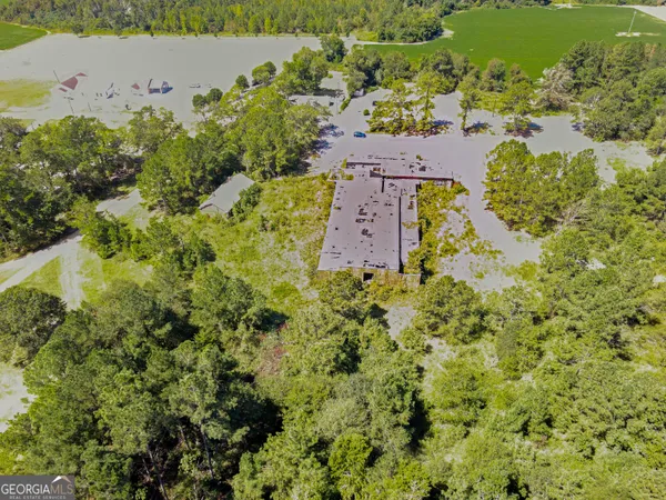 an aerial view of a house with a yard