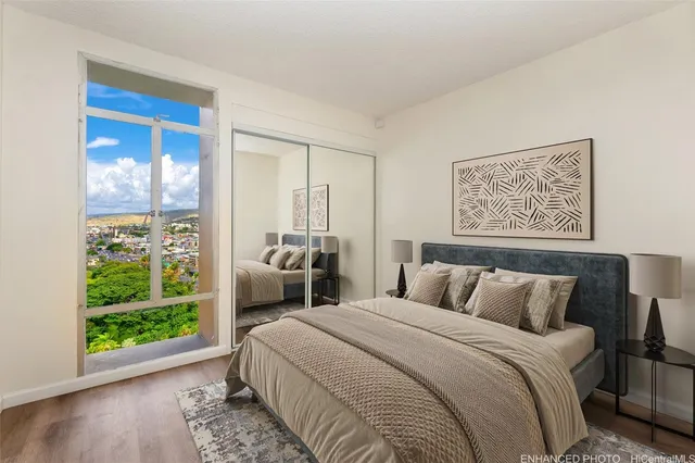 a bedroom with a bed and a large window