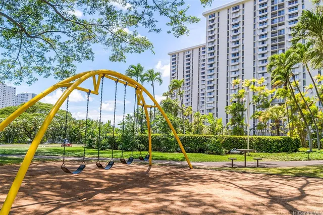 a view of a tall building with a park