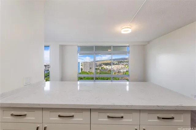 a view of room with window and potted plants