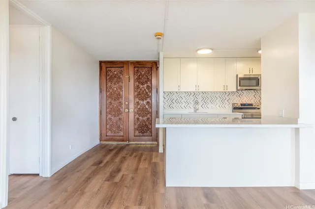 a view of kitchen with granite countertop cabinets and wooden floor