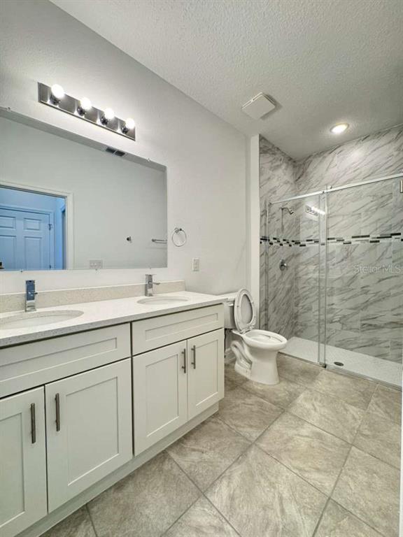 16054 Southwest 55th Avenue Road Ocala, FL 34473 - Photo 26 of 58 a spacious bathroom with a double vanity sink mirror and toilet
