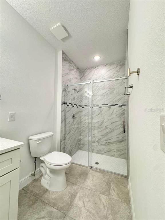 16054 Southwest 55th Avenue Road Ocala, FL 34473 - Photo 28 of 58 a bathroom with a toilet and a shower