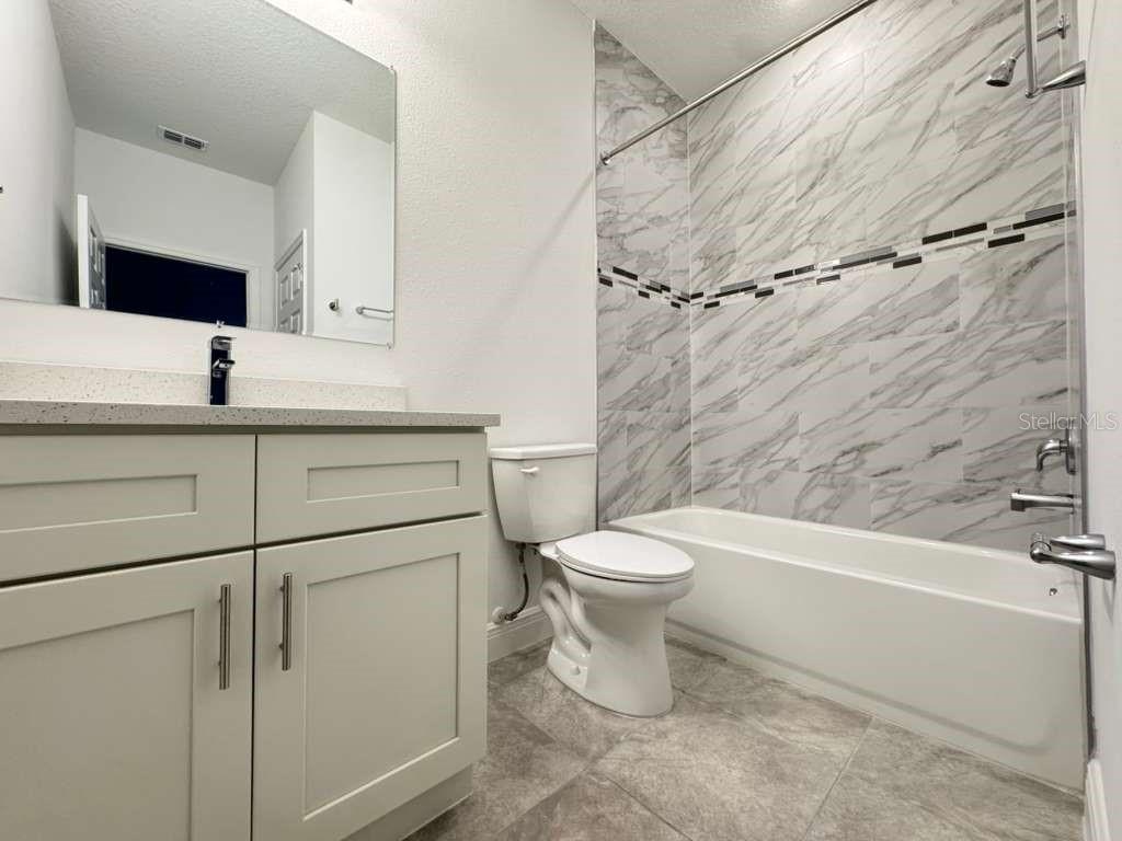 16054 Southwest 55th Avenue Road Ocala, FL 34473 - Photo 38 of 58 a bathroom with a toilet sink and shower
