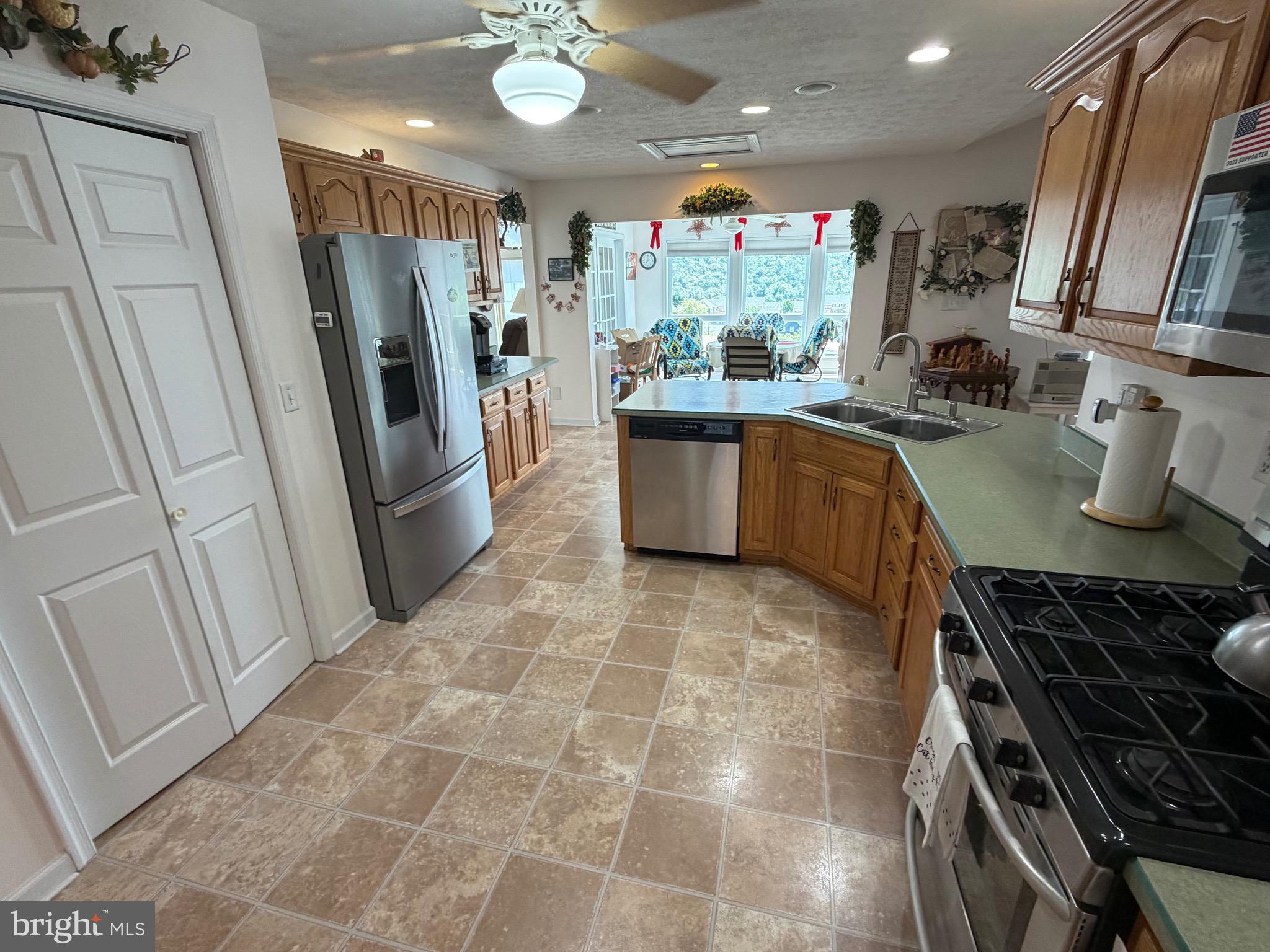 1565 Liberty Street Keyser, WV 26726 - Photo 11 of 95 a kitchen with stainless steel appliances granite countertop a refrigerator stove and sink