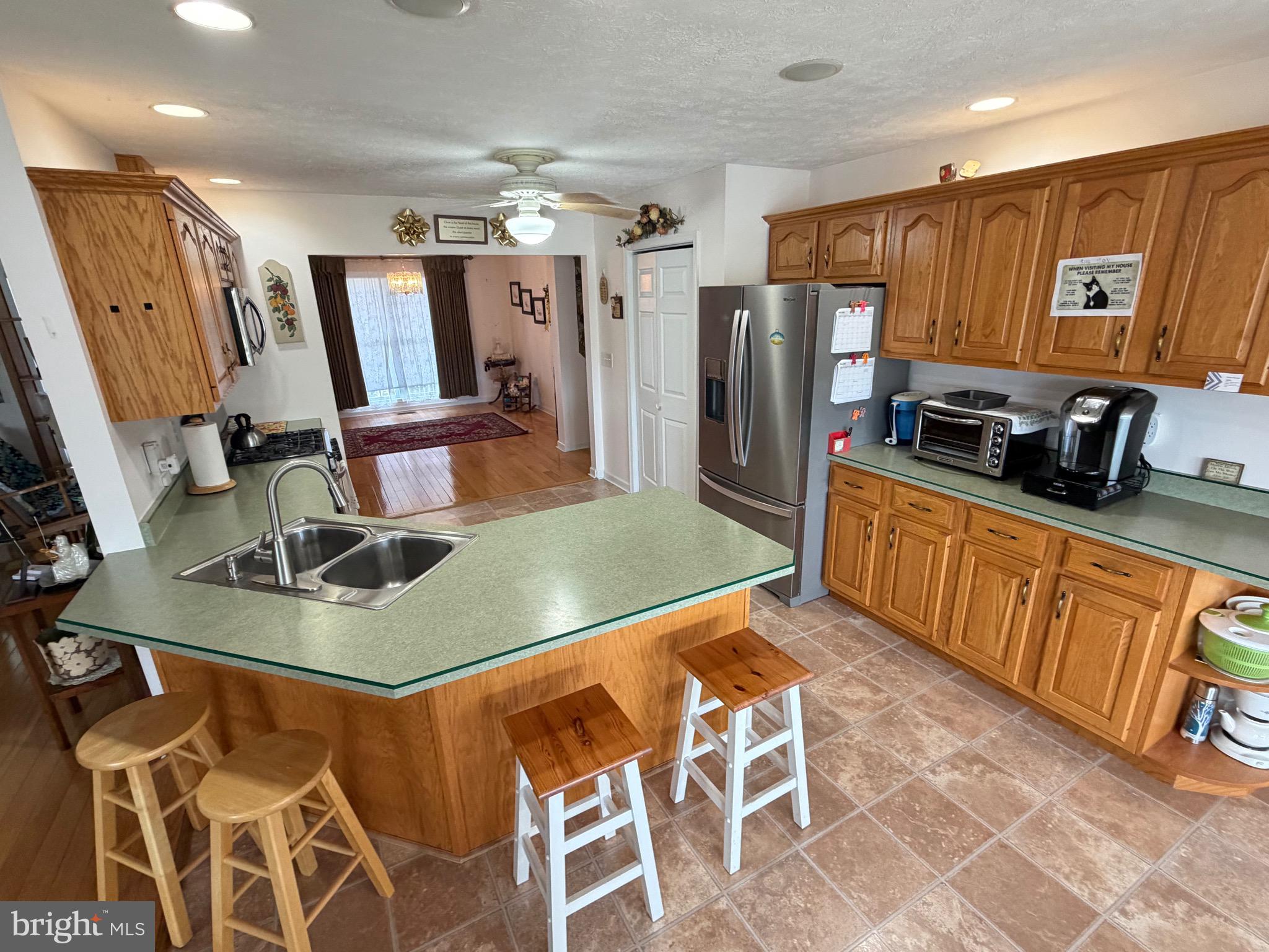 1565 Liberty Street Keyser, WV 26726 - Photo 12 of 95 a kitchen with stainless steel appliances granite countertop a refrigerator a stove and a sink