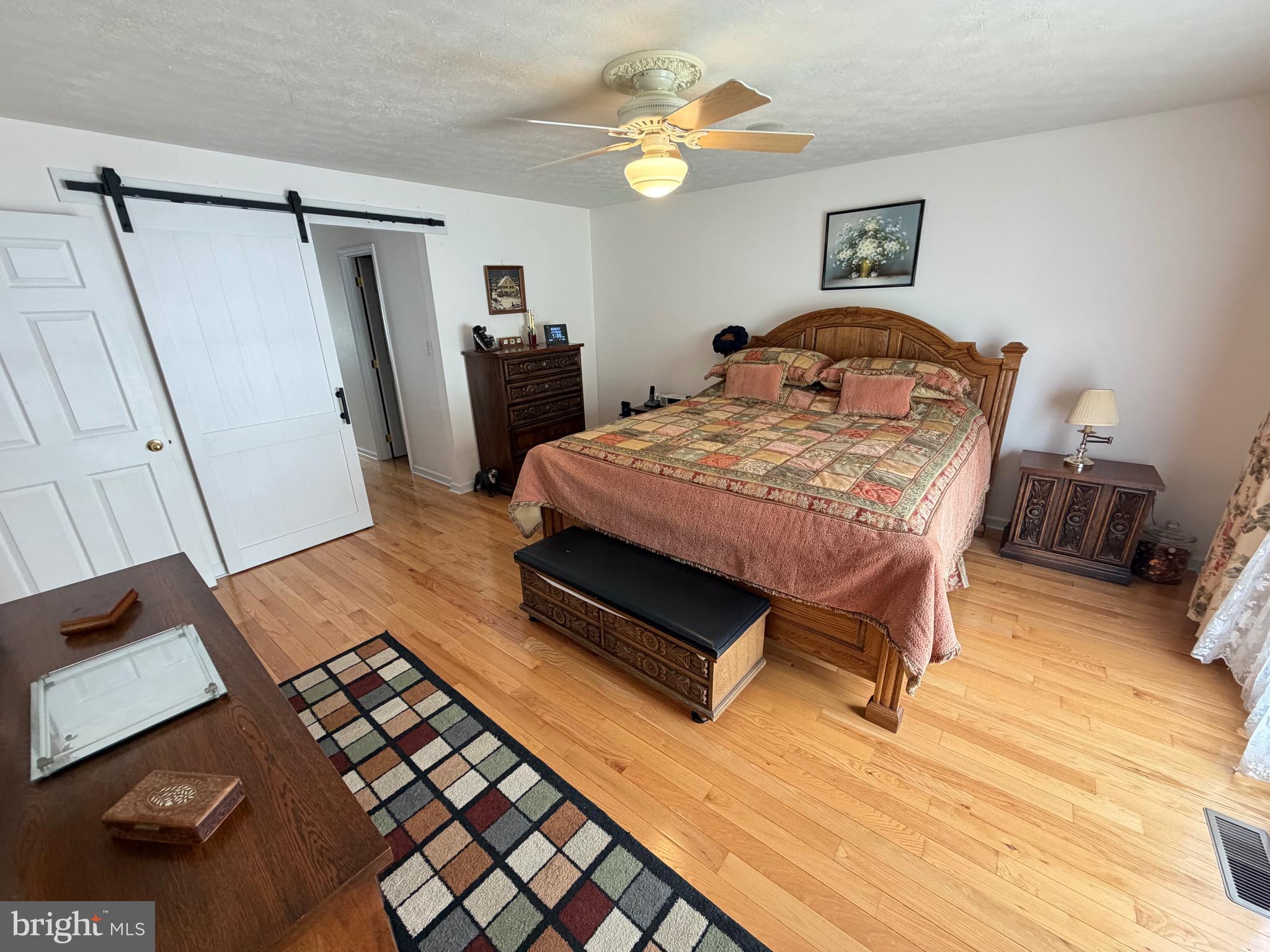 1565 Liberty Street Keyser, WV 26726 - Photo 19 of 95 a bedroom with a bed and a mirror on the dresser