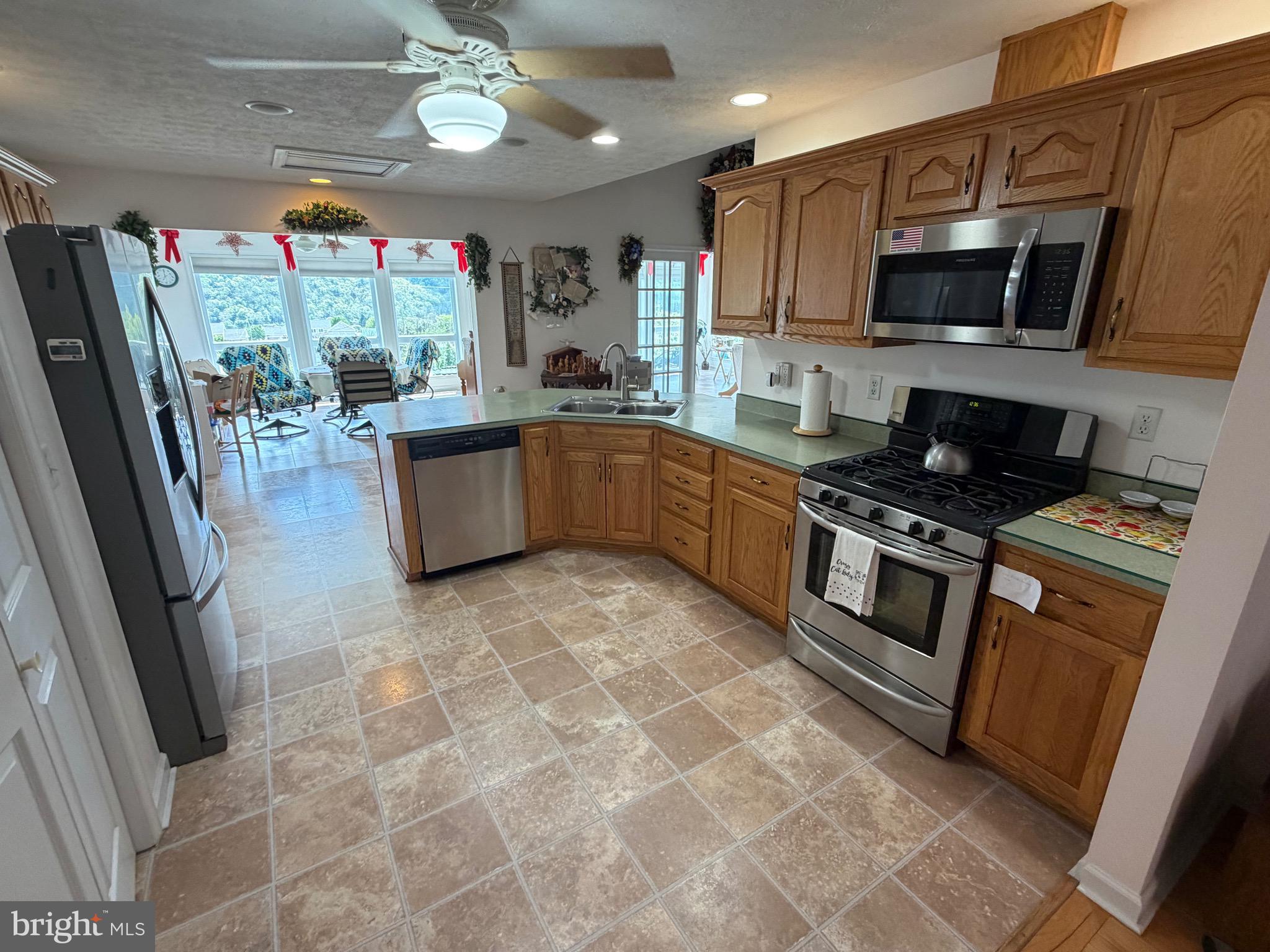 1565 Liberty Street Keyser, WV 26726 - Photo 10 of 95 a kitchen with stainless steel appliances granite countertop a refrigerator a stove top oven a sink and dishwasher