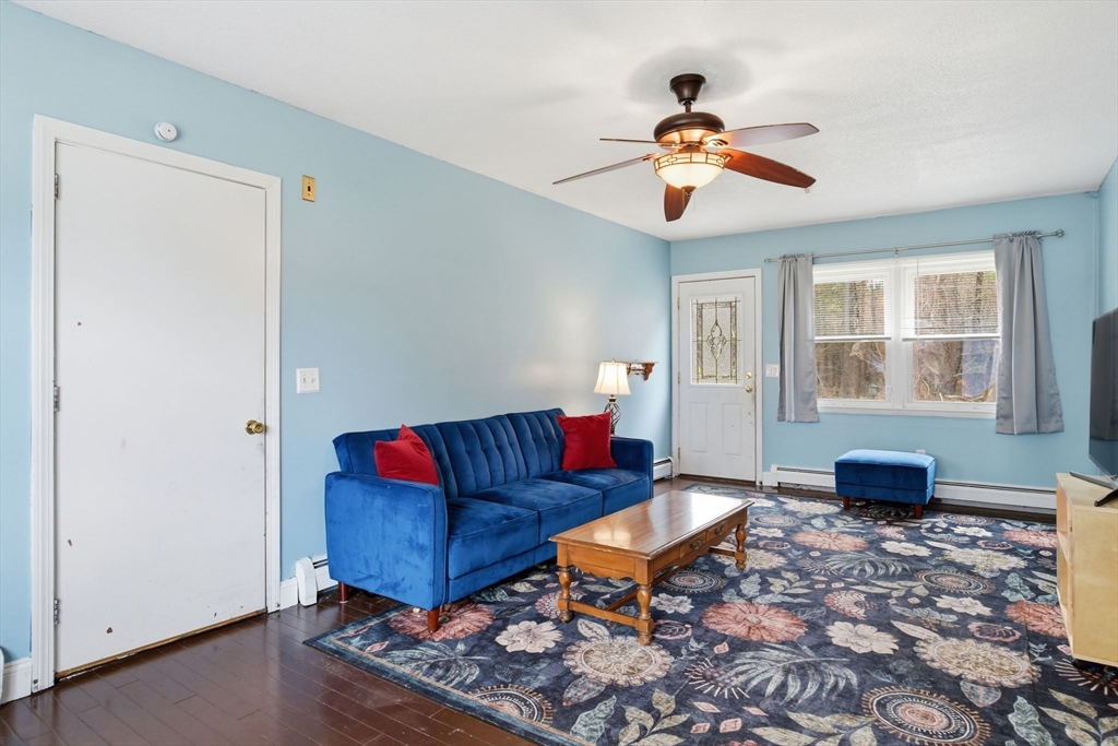 244 Lower Westfield Road Holyoke, MA 01040 - Photo 11 of 39 a living room with furniture a window and a chandelier