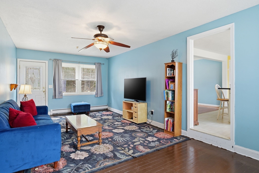 244 Lower Westfield Road Holyoke, MA 01040 - Photo 12 of 39 a living room with furniture and a flat screen tv