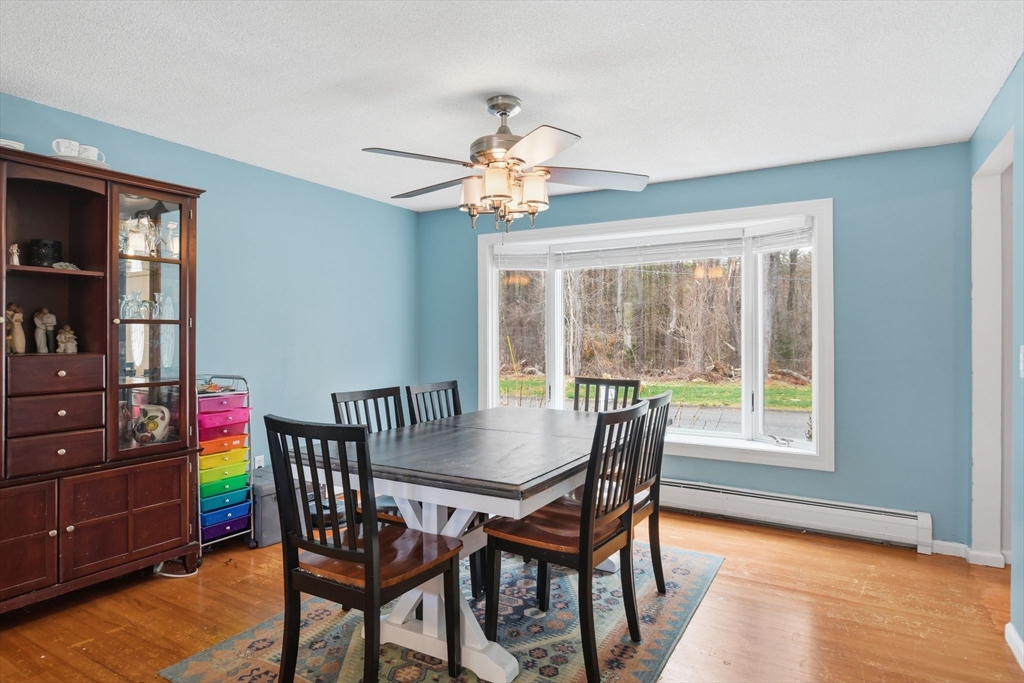 244 Lower Westfield Road Holyoke, MA 01040 - Photo 15 of 39 a dining room with furniture a chandelier and wooden floor
