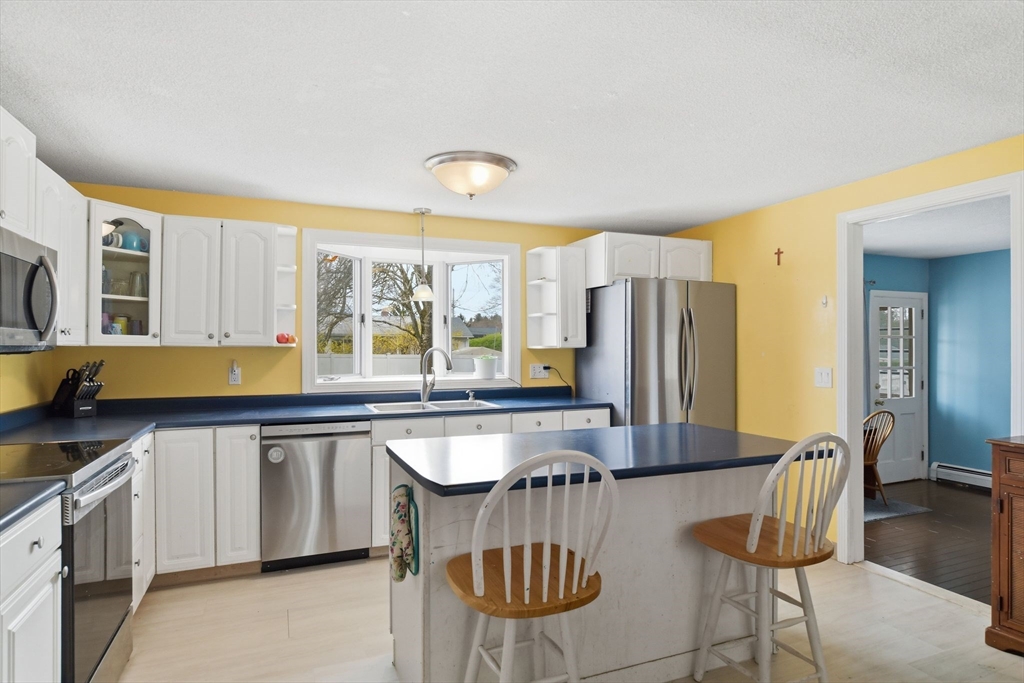 244 Lower Westfield Road Holyoke, MA 01040 - Photo 19 of 39 a kitchen with stainless steel appliances granite countertop a stove a sink and a refrigerator