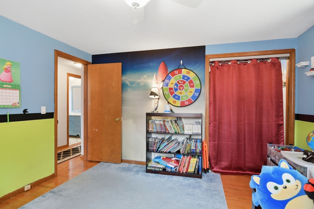 244 Lower Westfield Road Holyoke, MA 01040 - Photo 27 of 39 a living room with painting on the wall and a window