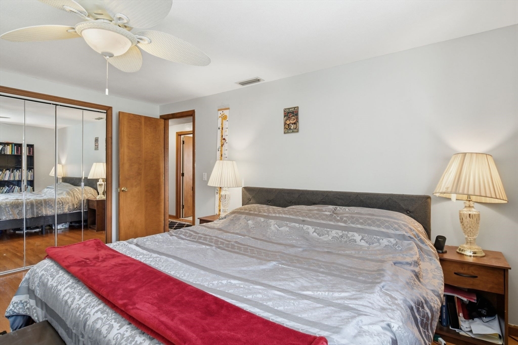 244 Lower Westfield Road Holyoke, MA 01040 - Photo 35 of 39 a bedroom with a bed and a chandelier