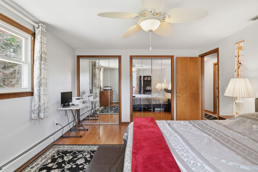 244 Lower Westfield Road Holyoke, MA 01040 - Photo 36 of 39 a bed room with a bed mirror and a window