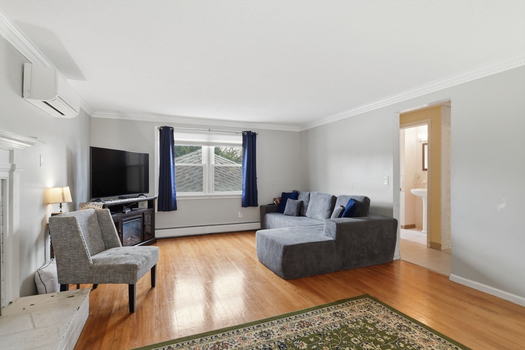 244 Lower Westfield Road Holyoke, MA 01040 - Photo 7 of 39 a living room with furniture and a flat screen tv