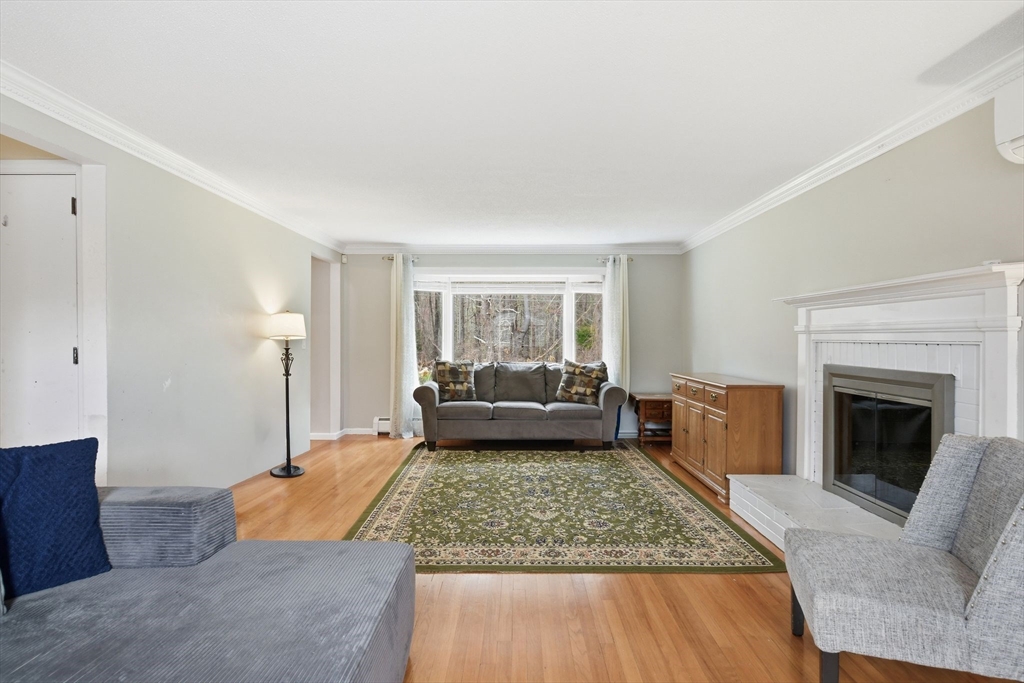 244 Lower Westfield Road Holyoke, MA 01040 - Photo 8 of 39 a living room with furniture and a fireplace