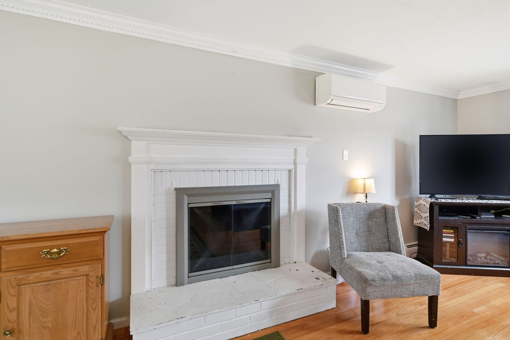 244 Lower Westfield Road Holyoke, MA 01040 - Photo 9 of 39 a living room with furniture and a fireplace