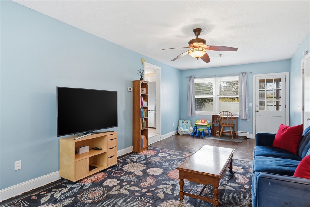 244 Lower Westfield Road Holyoke, MA 01040 - Photo 10 of 39 a living room with furniture and a flat screen tv