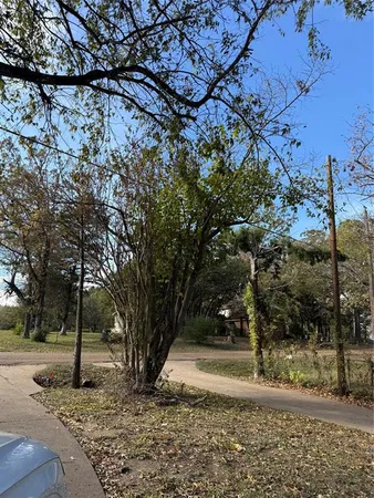 a view of a lake with a bench next to a yard