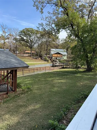 a view of a swimming pool with a patio and a yard
