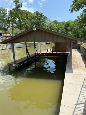 a blue swimming pool is sitting in the middle of a lake