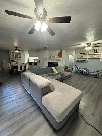 a bedroom with a bed wooden floor and window