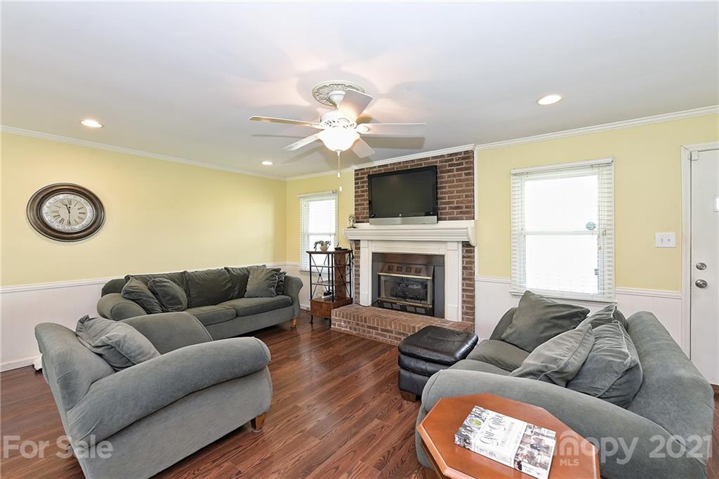 1721 Rock Rest Road Wingate, NC 28174 - Photo 11 of 47 a living room with furniture fireplace and a flat screen tv