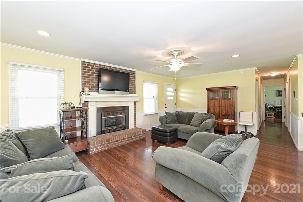 1721 Rock Rest Road Wingate, NC 28174 - Photo 12 of 47 a living room with furniture a fireplace and a flat screen tv