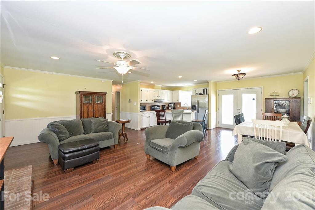 1721 Rock Rest Road Wingate, NC 28174 - Photo 13 of 47 a living room with furniture white walls and a chandelier