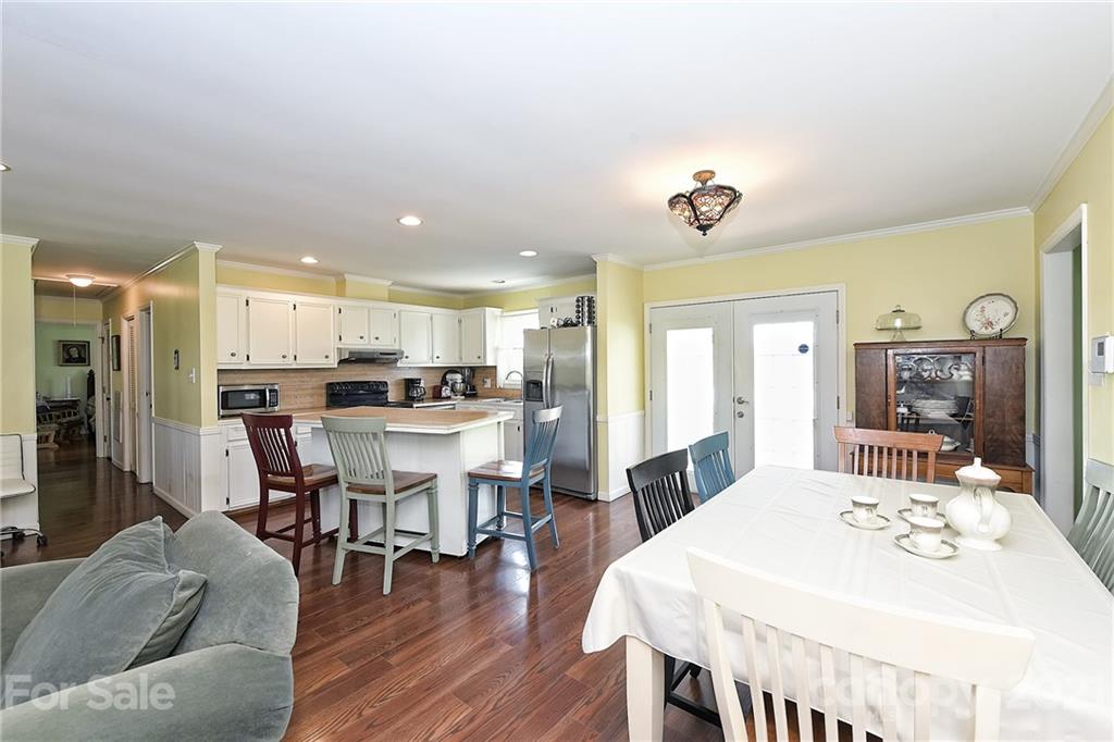 1721 Rock Rest Road Wingate, NC 28174 - Photo 18 of 47 a view of a dining room with furniture and wooden floor