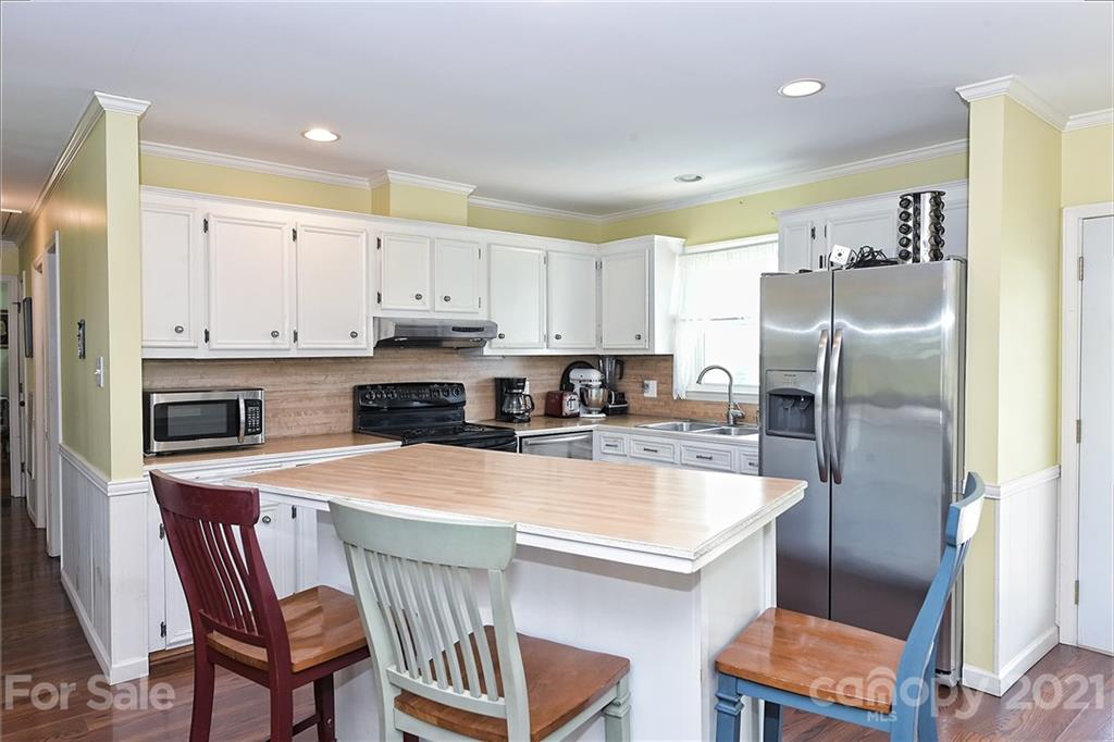 1721 Rock Rest Road Wingate, NC 28174 - Photo 21 of 47 a kitchen with a refrigerator a stove a sink and a refrigerator