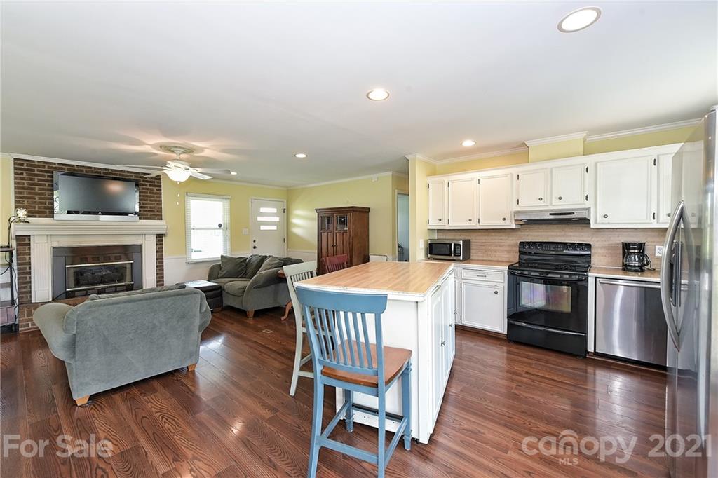1721 Rock Rest Road Wingate, NC 28174 - Photo 22 of 47 a kitchen with a table chairs microwave and cabinets