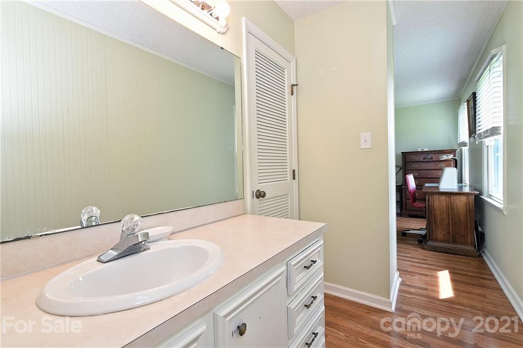 1721 Rock Rest Road Wingate, NC 28174 - Photo 24 of 47 a bathroom with a sink and a mirror