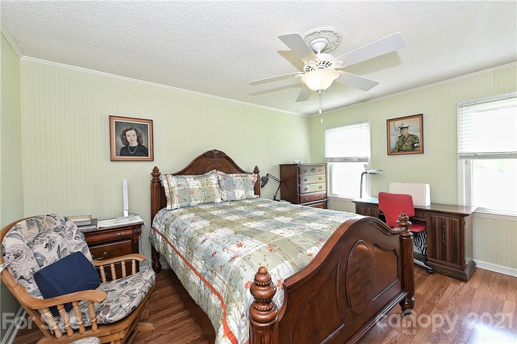 1721 Rock Rest Road Wingate, NC 28174 - Photo 25 of 47 a bed sitting in a bedroom next to a window with a table and chair