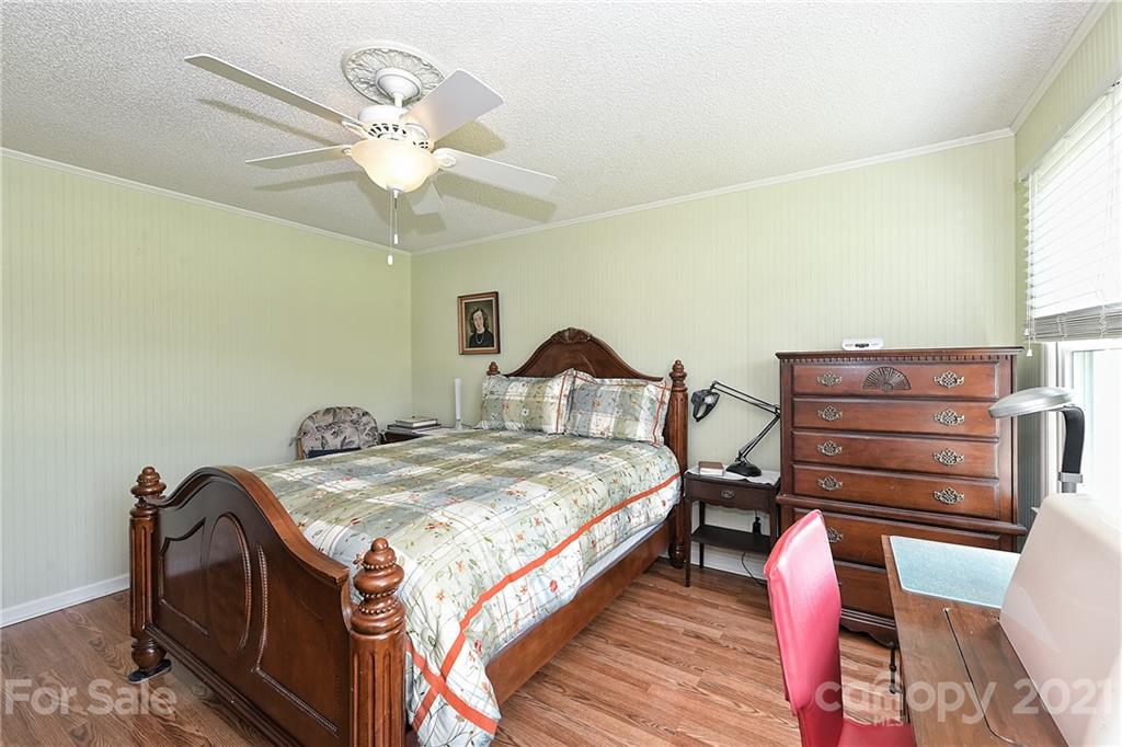 1721 Rock Rest Road Wingate, NC 28174 - Photo 26 of 47 a bedroom with bed and a chandelier