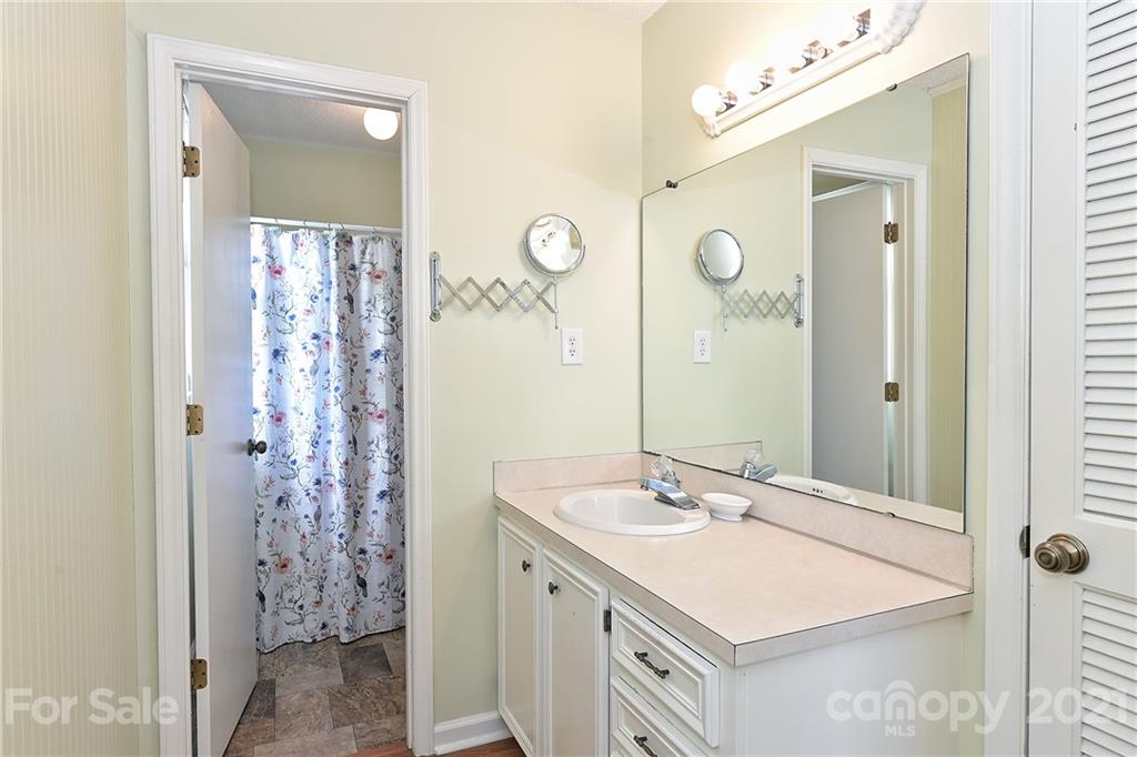 1721 Rock Rest Road Wingate, NC 28174 - Photo 27 of 47 a bathroom with a sink vanity and a mirror