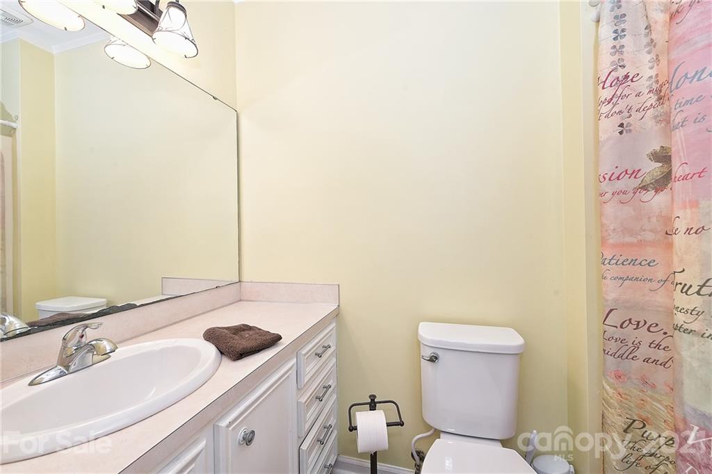 1721 Rock Rest Road Wingate, NC 28174 - Photo 30 of 47 a bathroom with a sink and a mirror