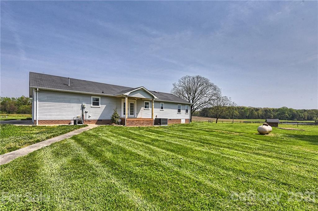 1721 Rock Rest Road Wingate, NC 28174 - Photo 35 of 47 a front view of a house with a yard and garage