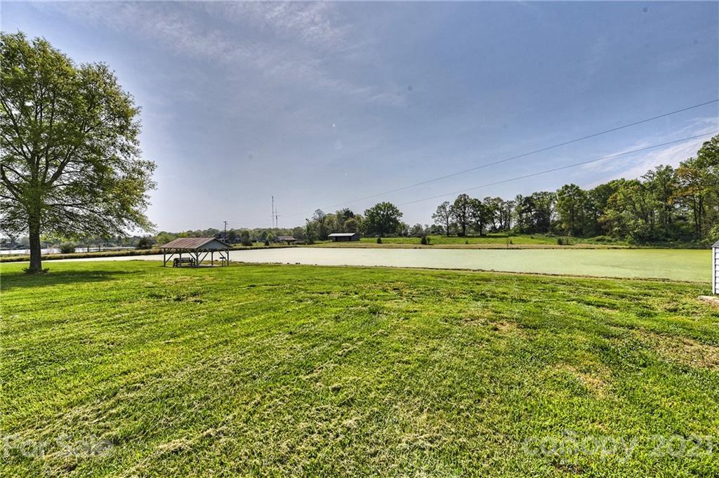 1721 Rock Rest Road Wingate, NC 28174 - Photo 36 of 47 a view of a green field with trees in the background