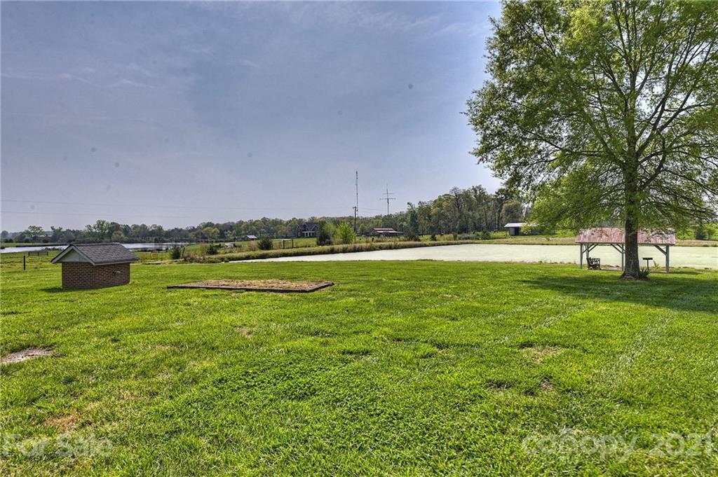 1721 Rock Rest Road Wingate, NC 28174 - Photo 39 of 47 a view of a green field with trees in the background