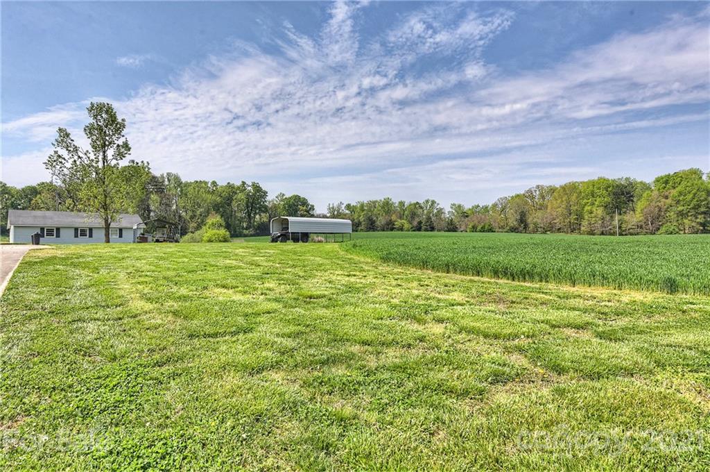 1721 Rock Rest Road Wingate, NC 28174 - Photo 42 of 47 a view of a green field with an trees