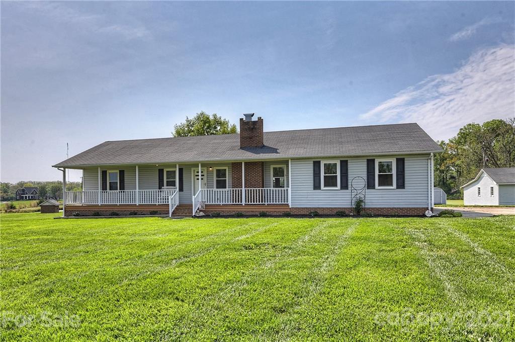 1721 Rock Rest Road Wingate, NC 28174 - Photo 7 of 47 a front view of a house with a garden