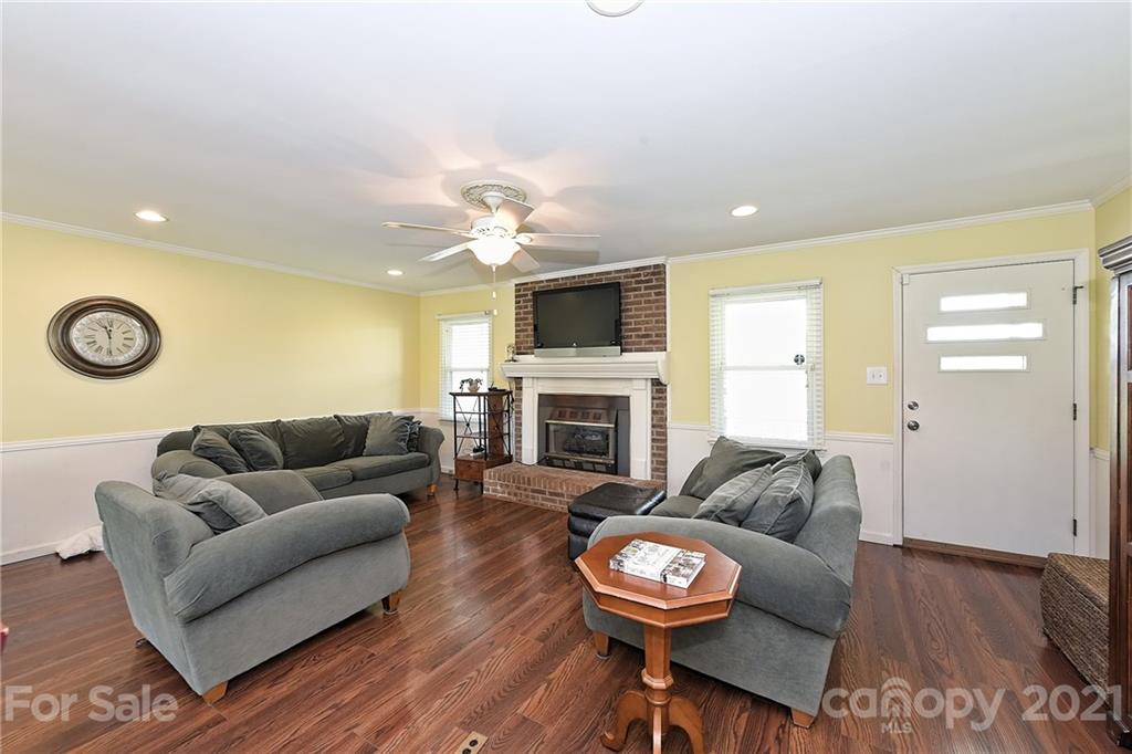 1721 Rock Rest Road Wingate, NC 28174 - Photo 10 of 47 a living room with furniture a fireplace and a flat screen tv