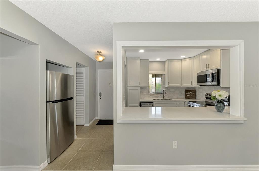1618 Stickney Point Road, Unit 1618202 Sarasota, FL 34231 - Photo 19 of 58 a kitchen with stainless steel appliances a refrigerator and a sink