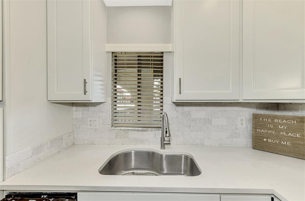 1618 Stickney Point Road, Unit 1618202 Sarasota, FL 34231 - Photo 25 of 58 a close view of sink and tap