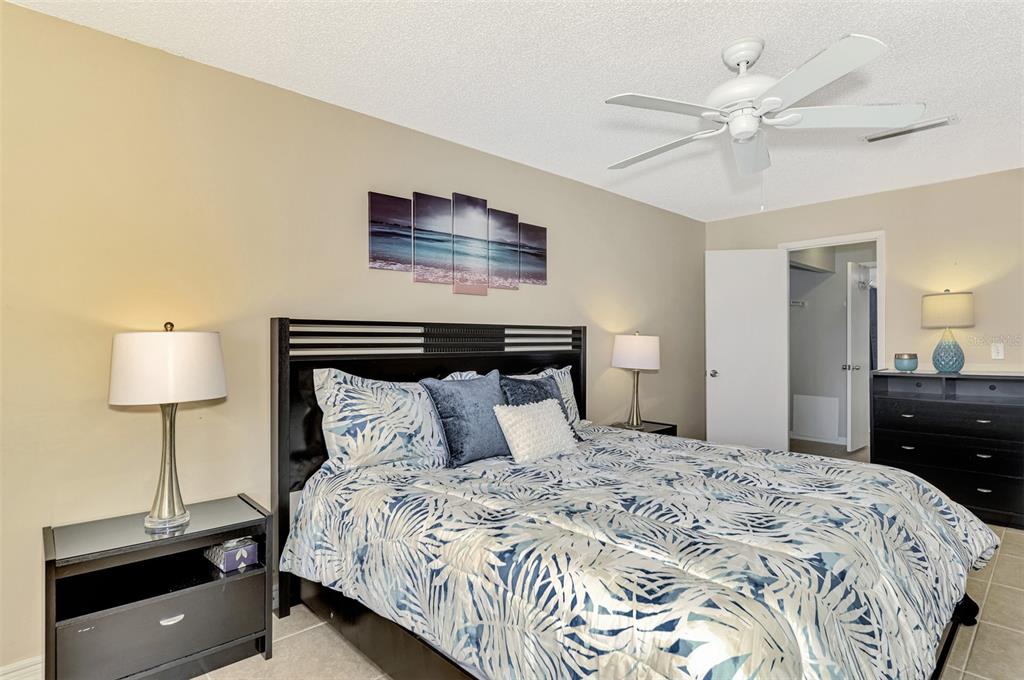 1618 Stickney Point Road, Unit 1618202 Sarasota, FL 34231 - Photo 30 of 58 a bedroom with a bed and a lamp