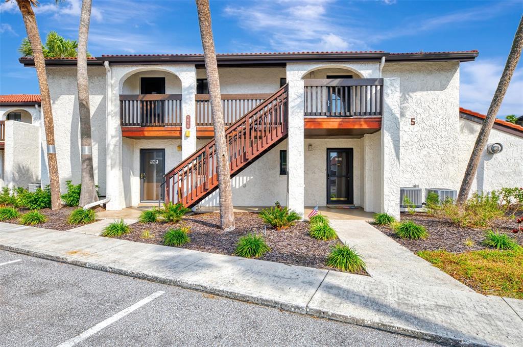 1618 Stickney Point Road, Unit 1618202 Sarasota, FL 34231 - Photo 5 of 58 a front view of a house with garden