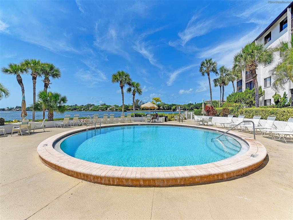 1618 Stickney Point Road, Unit 1618202 Sarasota, FL 34231 - Photo 52 of 58 a view of swimming pool with outdoor seating and plants