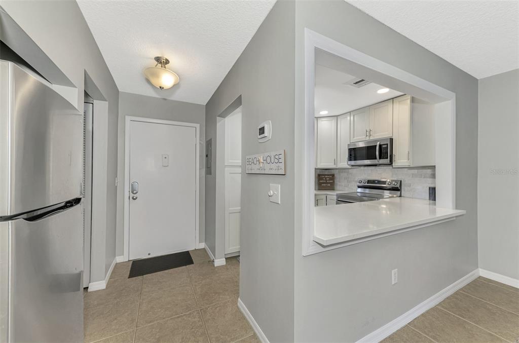 1618 Stickney Point Road, Unit 1618202 Sarasota, FL 34231 - Photo 7 of 58 a kitchen with stainless steel appliances a refrigerator sink and microwave